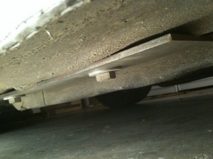 View of outboard backing plate under car